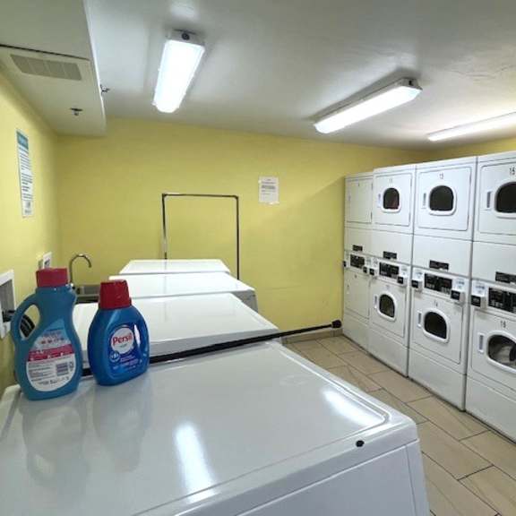 a laundromat with rows of washers and dryers.
