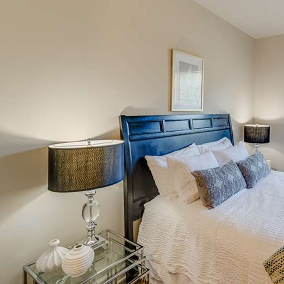 bedroom with large windows and side tables