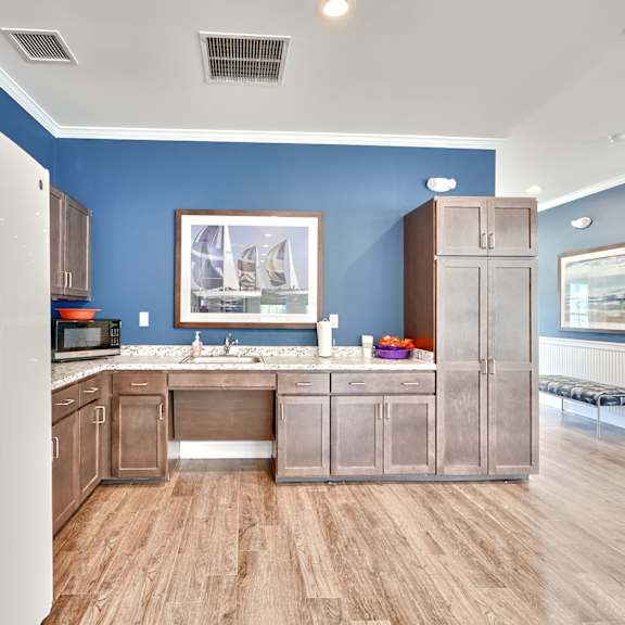 a kitchen with stainless steel appliances and blue walls