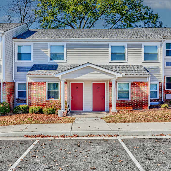an apartment building with a red door