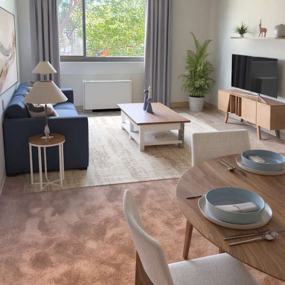 a modern living room with a blue sofa, wooden coffee table, and a television.