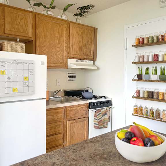 a white fridge with a calendar on it in a kitchen.