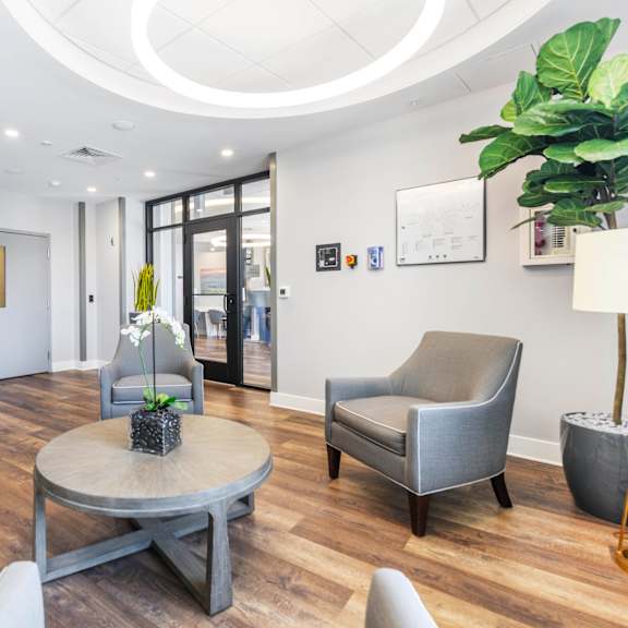a waiting room with white walls and a wooden floor