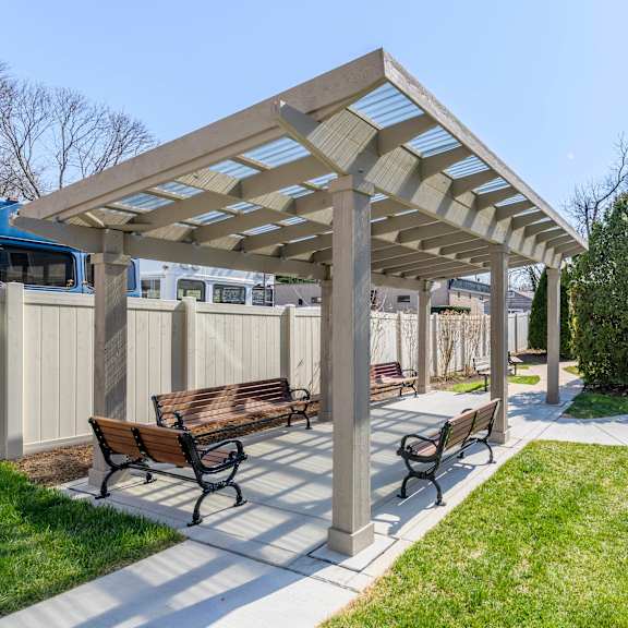a picnic area with benches and a pergola