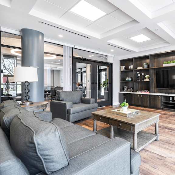 a living room filled with furniture and a large tv