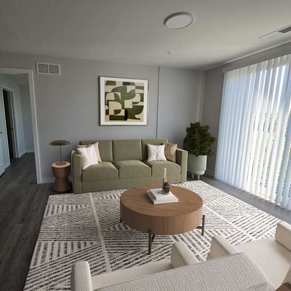 a living room with a green couch, a wooden coffee table, and a rug.