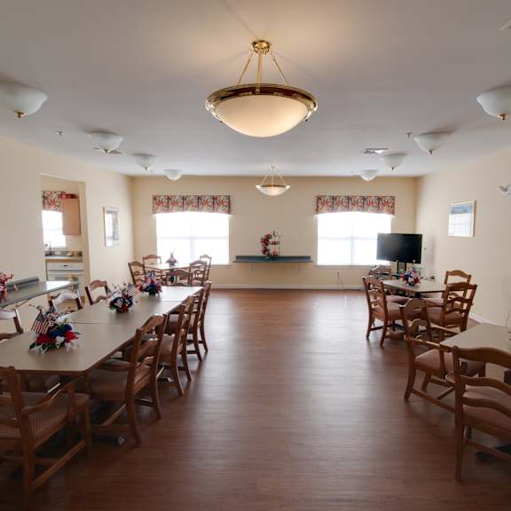 a dining room with tables and chairs in a multipurpose room