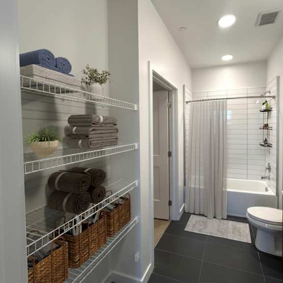 a bathroom with a towel rack, a toilet, a sink, and a shower.
