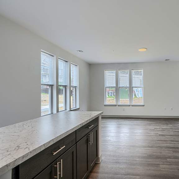 a kitchen with a white fridge and black cabinets.