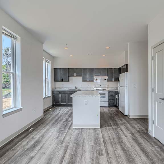 a kitchen with a white island in the middle of the room.