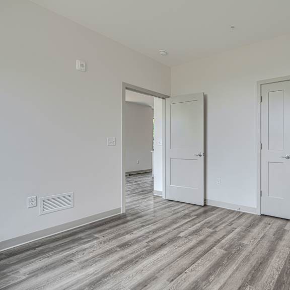 a room with a grey floor and white walls.