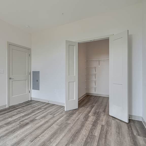 a room with a wooden floor and white walls.