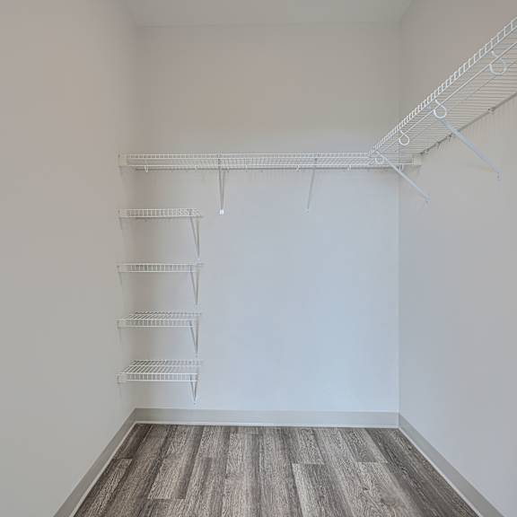 empty room with white walls and a wooden floor.