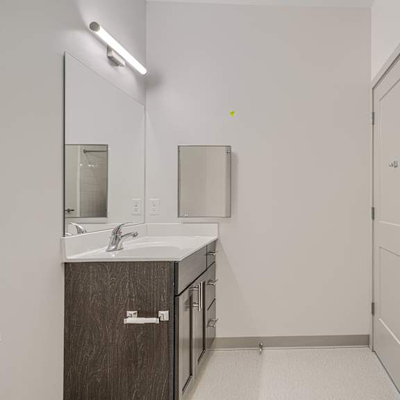 a bathroom with a sink, mirror, and medicine cabinet.