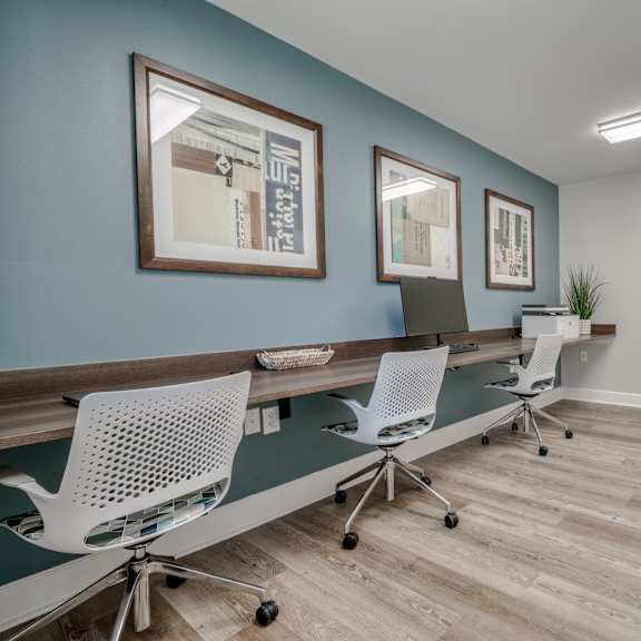 a conference room with a long desk and three chairs