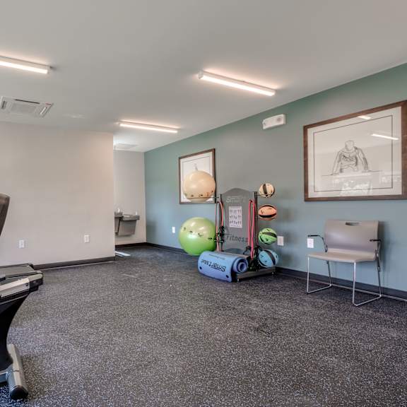 gym with exercise equipment at the district flats apartments in lenexa
