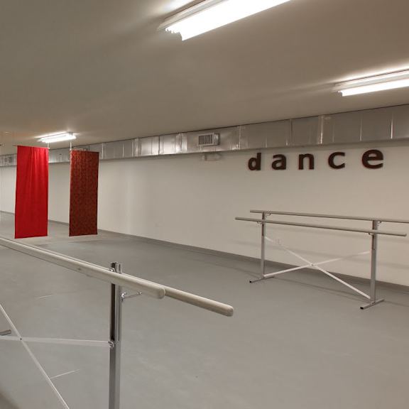 a dance studio with mirrors and barres.
