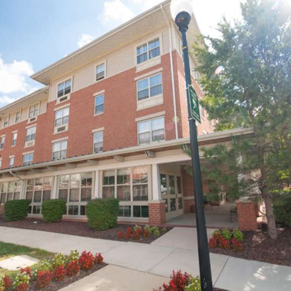 a large brick building with a sidewalk in front of it