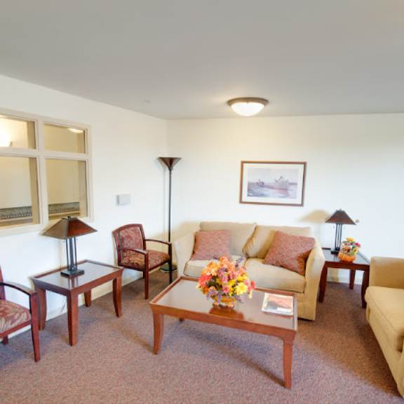 a living room with a couch and chairs and a table