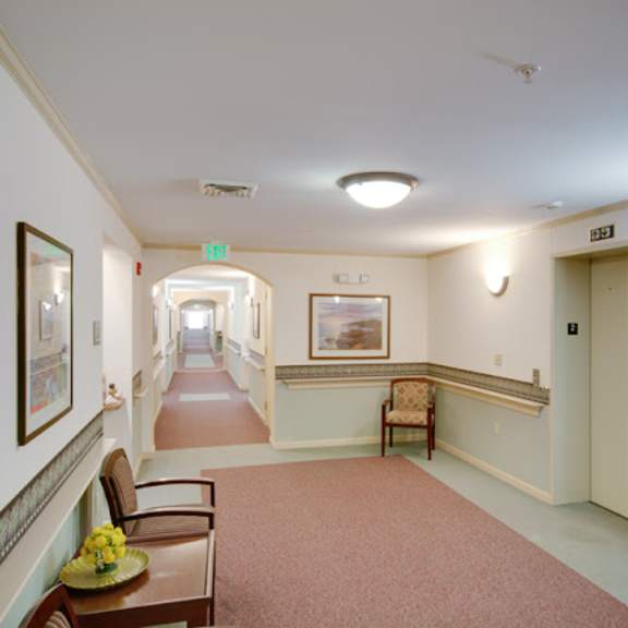 a long hallway with chairs and a table