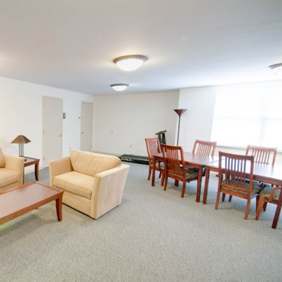 a living room and dining room with a table and chairs
