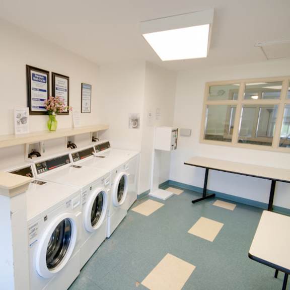 a laundry room with washing machines and a table