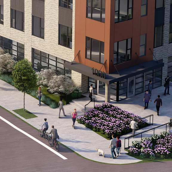 a street view of a building with a flower bed in front of it.