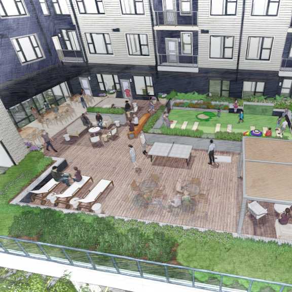 a rooftop garden with a seating area and a green lawn.