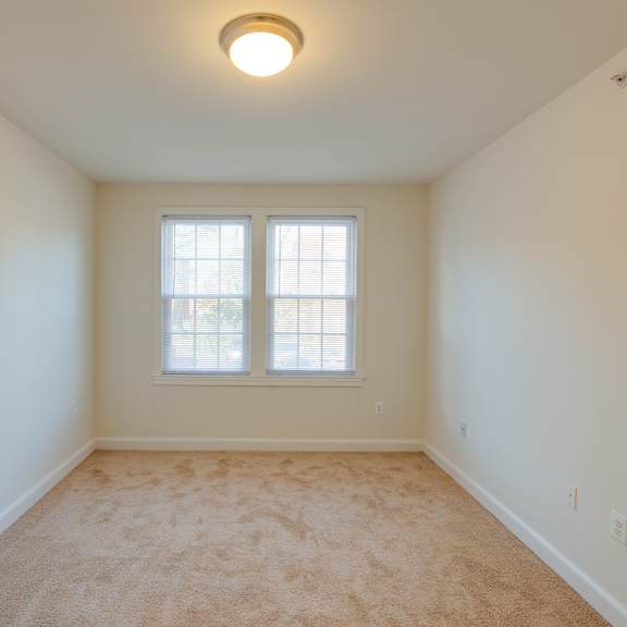 carpeted bedroom with large window