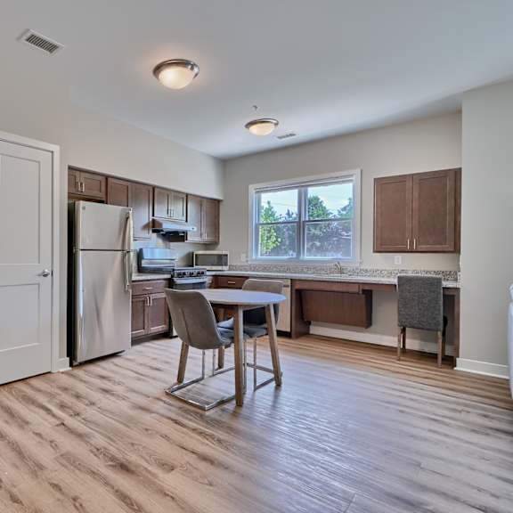 a kitchen with a table and chairs in the middle of the room.