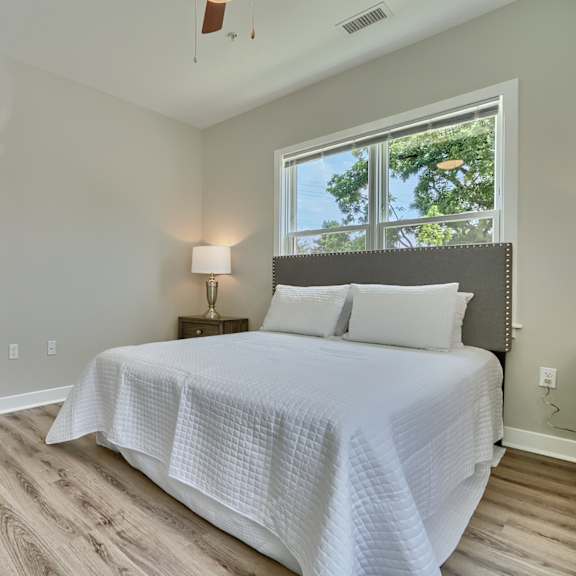 a bedroom with a large bed and a window.