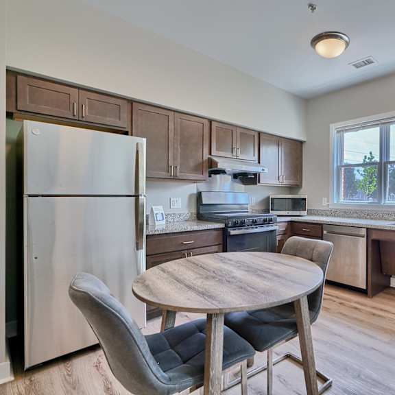 a kitchen with a table and chairs.