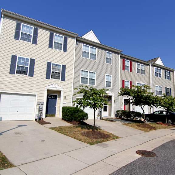 a row of townhomes with a blue sky in the background