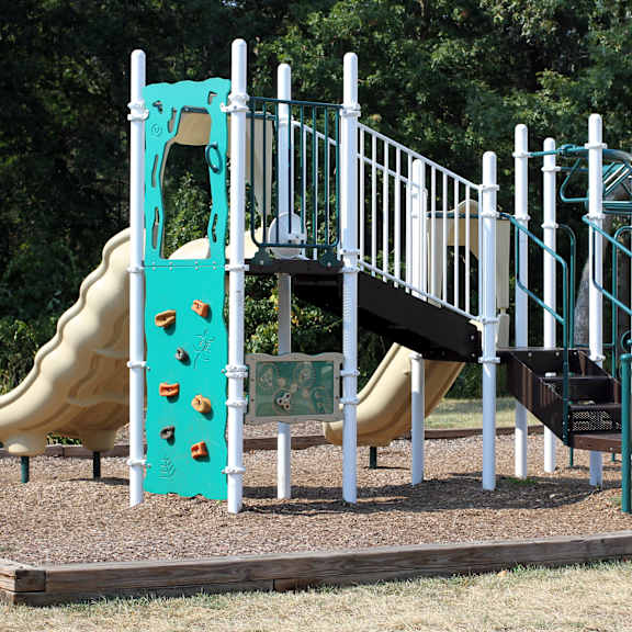 community playground with a slide and climbing equipment