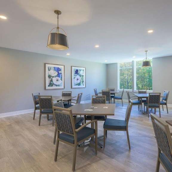 a dining room with a long table and chairs.