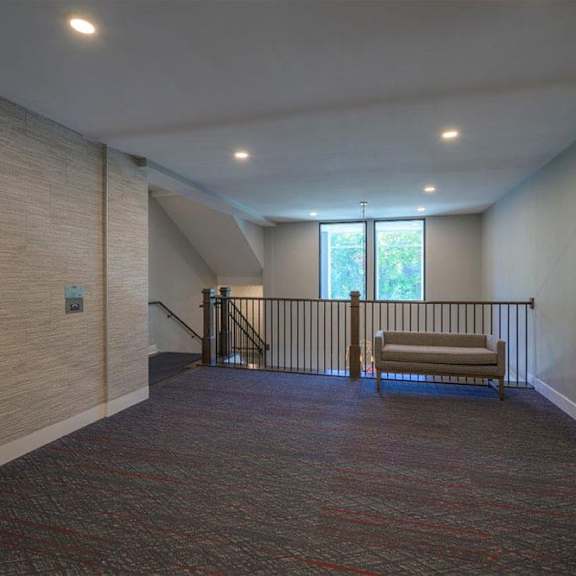 a hallway with a bench and a window.