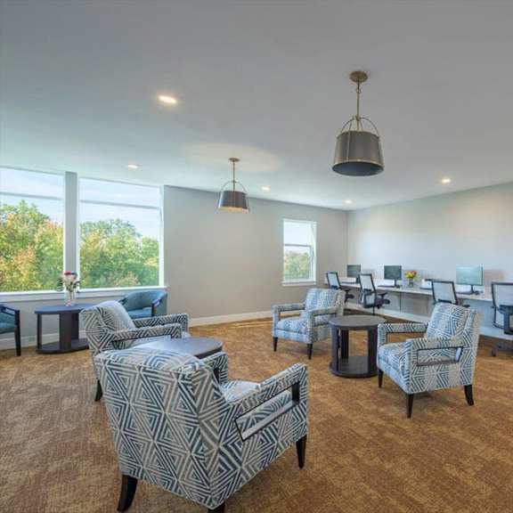 a room with a carpeted floor and a painting on the wall.