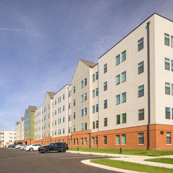 a parking lot in front of a multi-story building.
