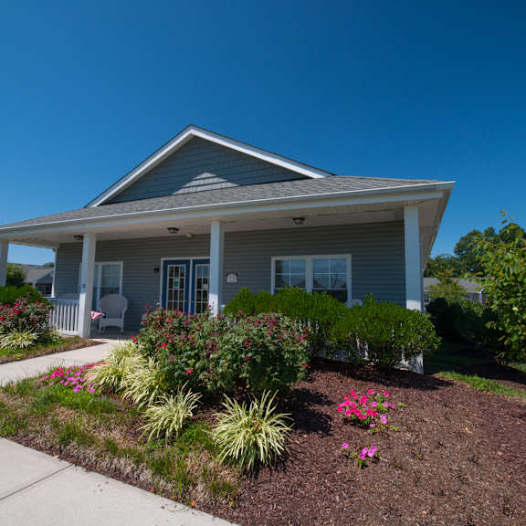 a house with a grey roof and a white front porch.