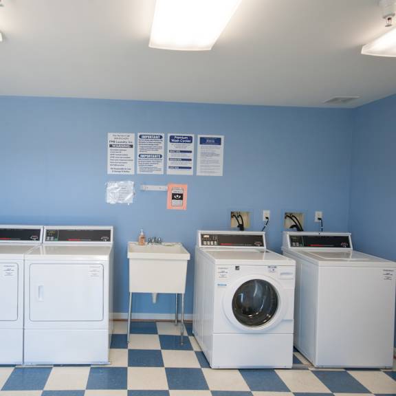 a laundromat with washers and dryers in it.