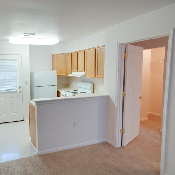 a kitchen area with white cabinets and appliances.