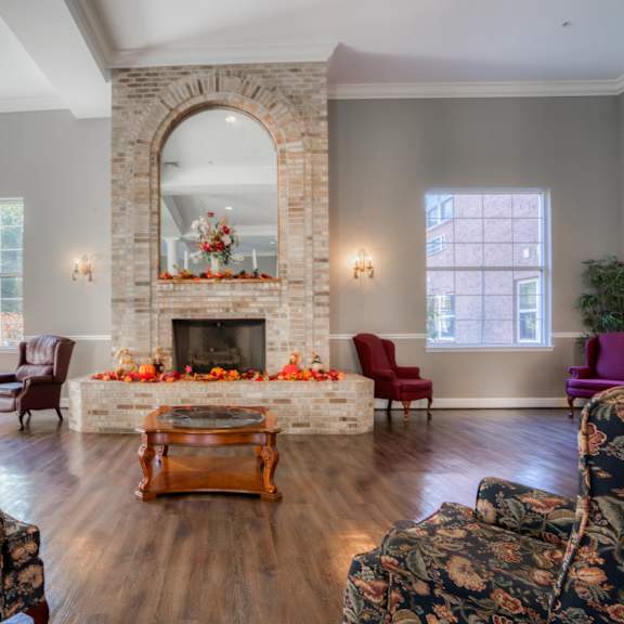 the living room of a home with a large stone fireplace