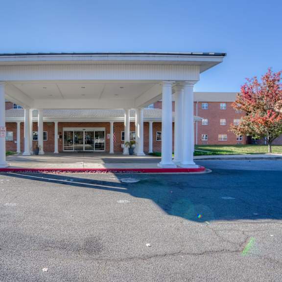 a covered parking lot with a building in the background
