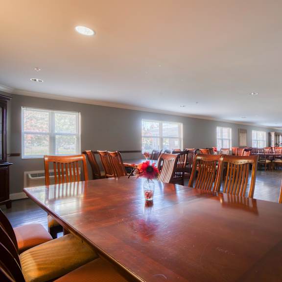 a large dining room with a large wooden table and chairs