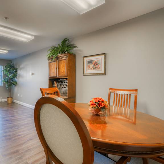 a dining room and living room with a table and chairs