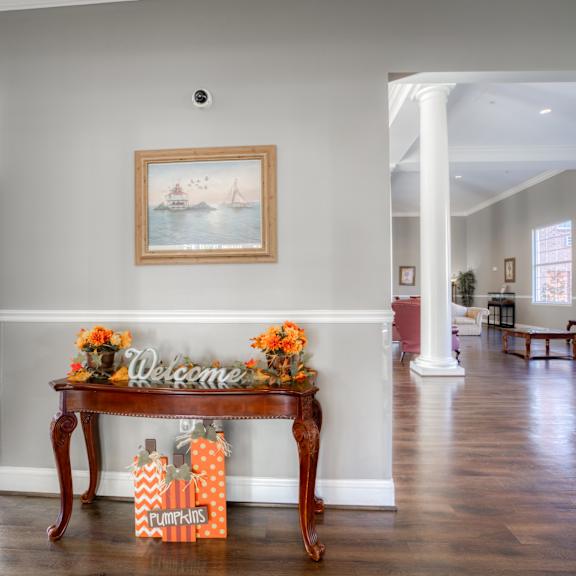 a living room with a table with orange flowers on it