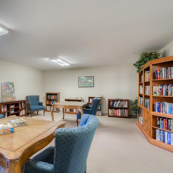 a library with tables and chairs and shelves of books