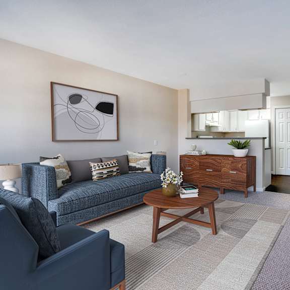 a living room with a blue couch and a coffee table