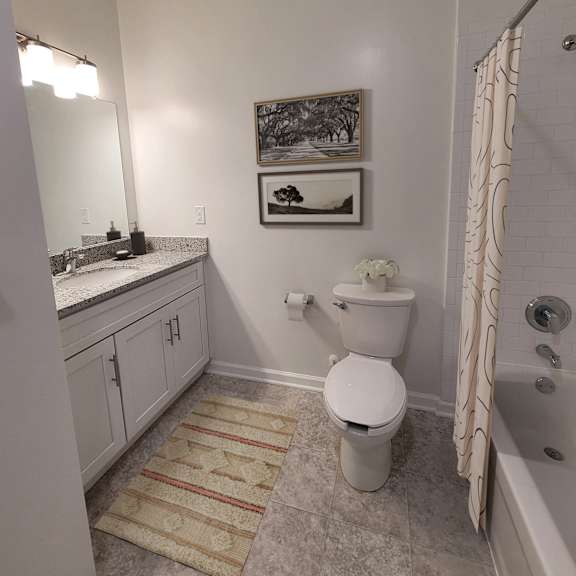 a bathroom with a toilet and a sink and a shower