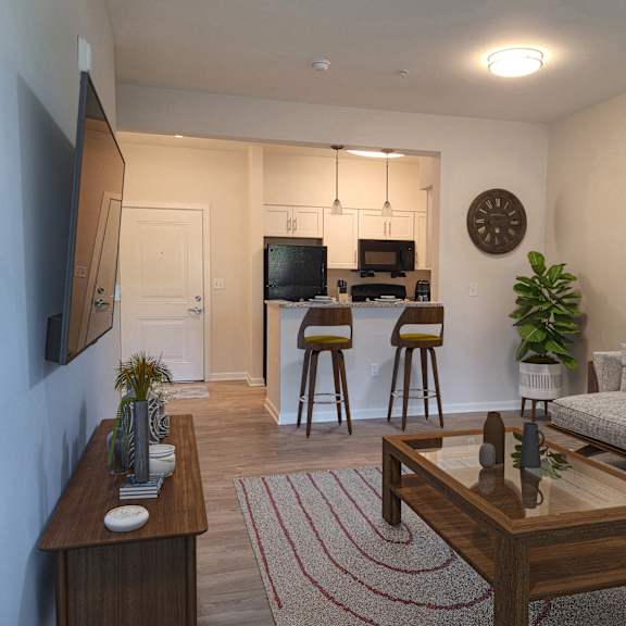 a living room and kitchen with a couch and a table